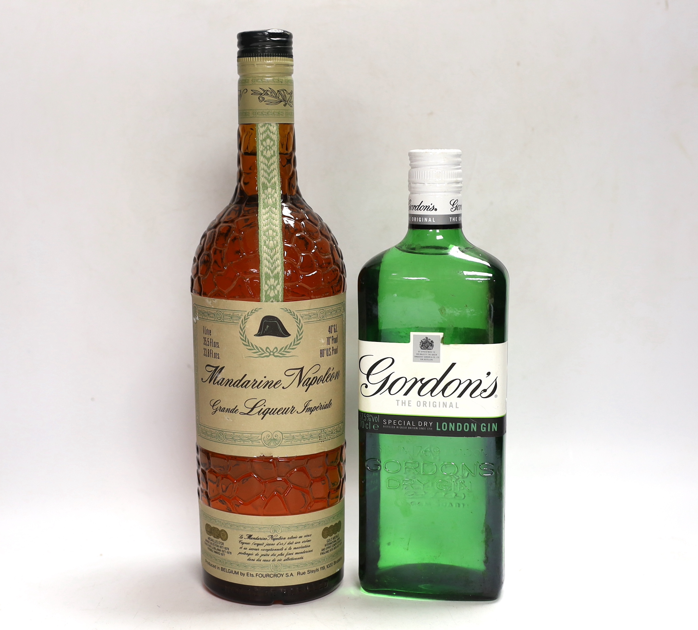 A bottle of Mandarine Napoleon brandy and a Gordon's gin